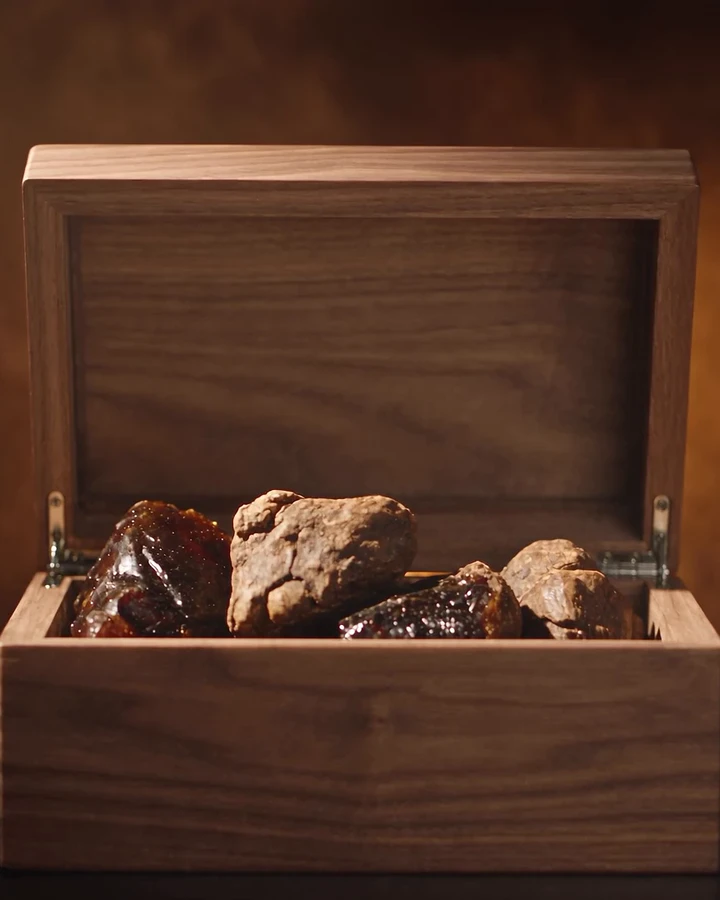 The open walnut box with raw resins inside