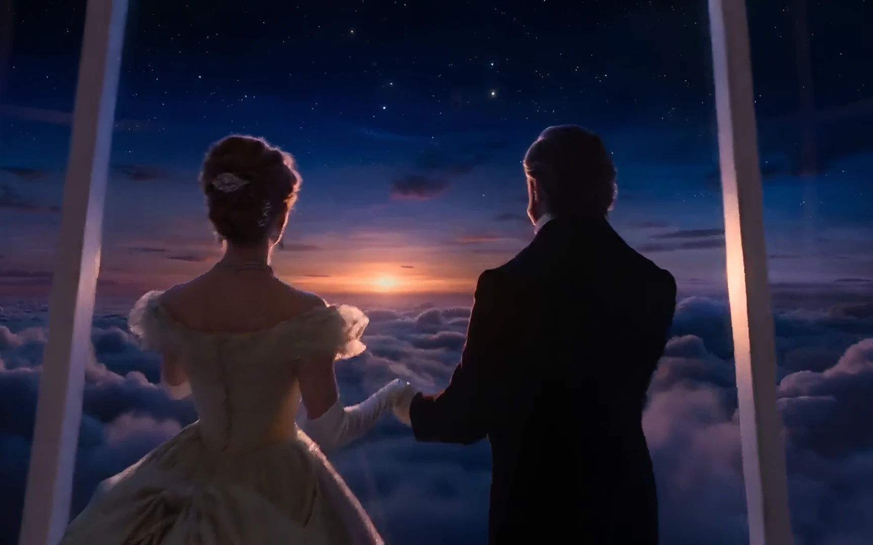A couple in evening dress holding hands at the window, the sun setting over the clouds under the first stars