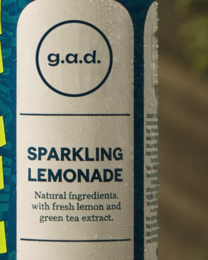 The teal g.a.d. can with the ring logo, covered in drops