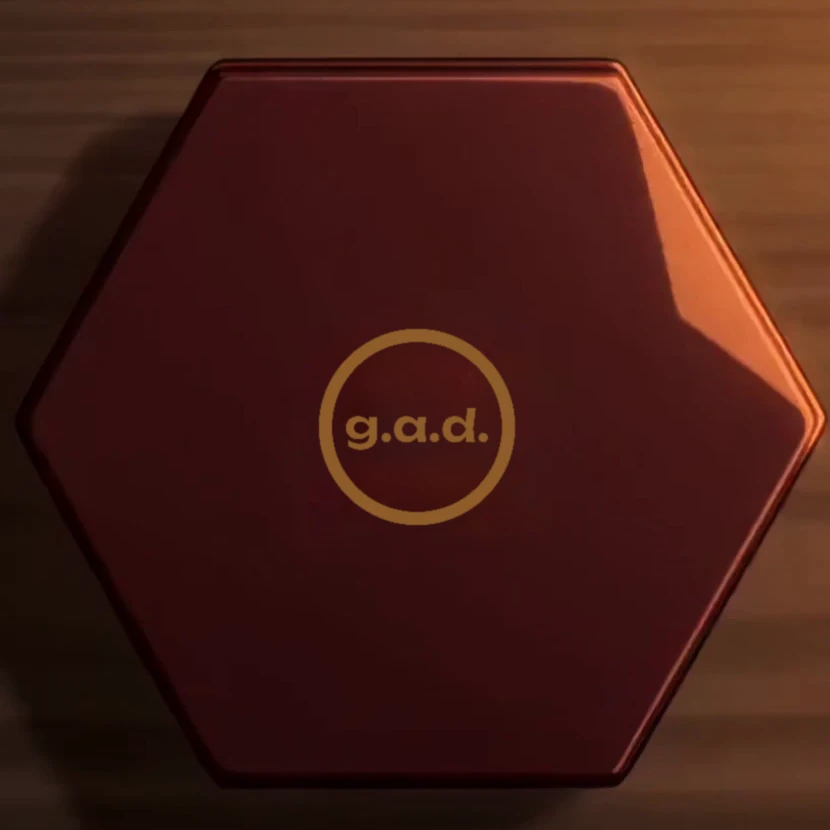 A red lacquer hexagonal tea caddy with the gold g.a.d. seal on its lid