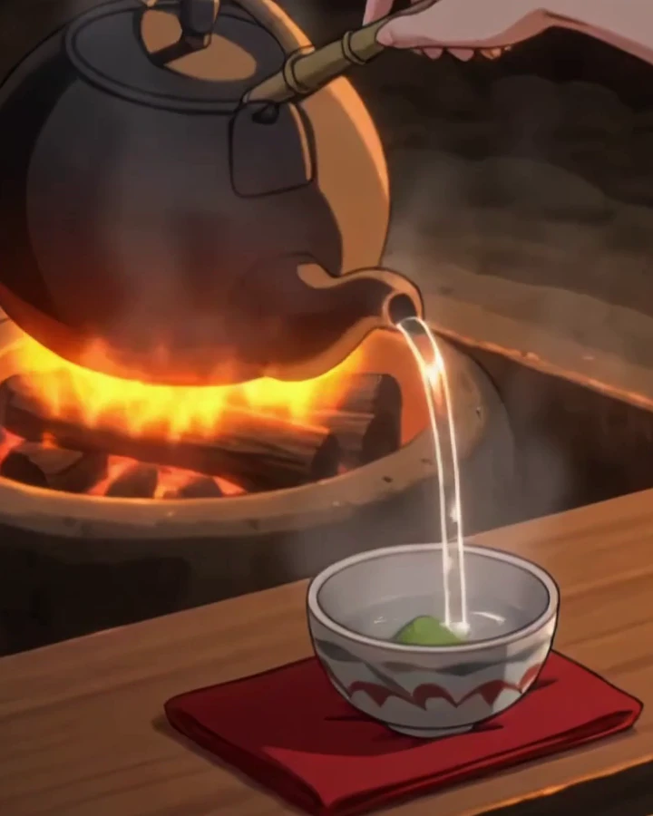 An iron kettle over glowing charcoal, hot water poured into a small bowl