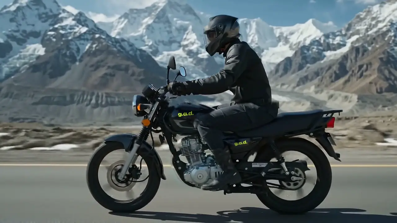 Side view of the rider on the black 150cc bike, a glacier behind